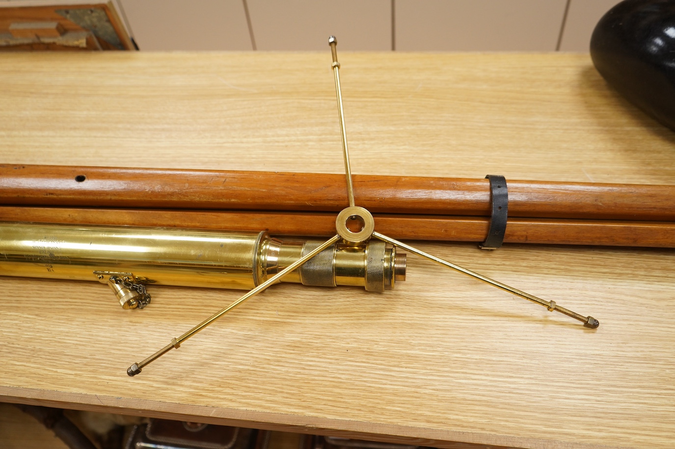 An early 20th century brass telescope with teak tripod by W. Ottway & Co., engraved with; Orion Works Ealing, ‘No.1058, VP 7 to 21 Day & Night Sight Patent 1906’, telescope 65cm long, tripod 160cm. Condition - good.